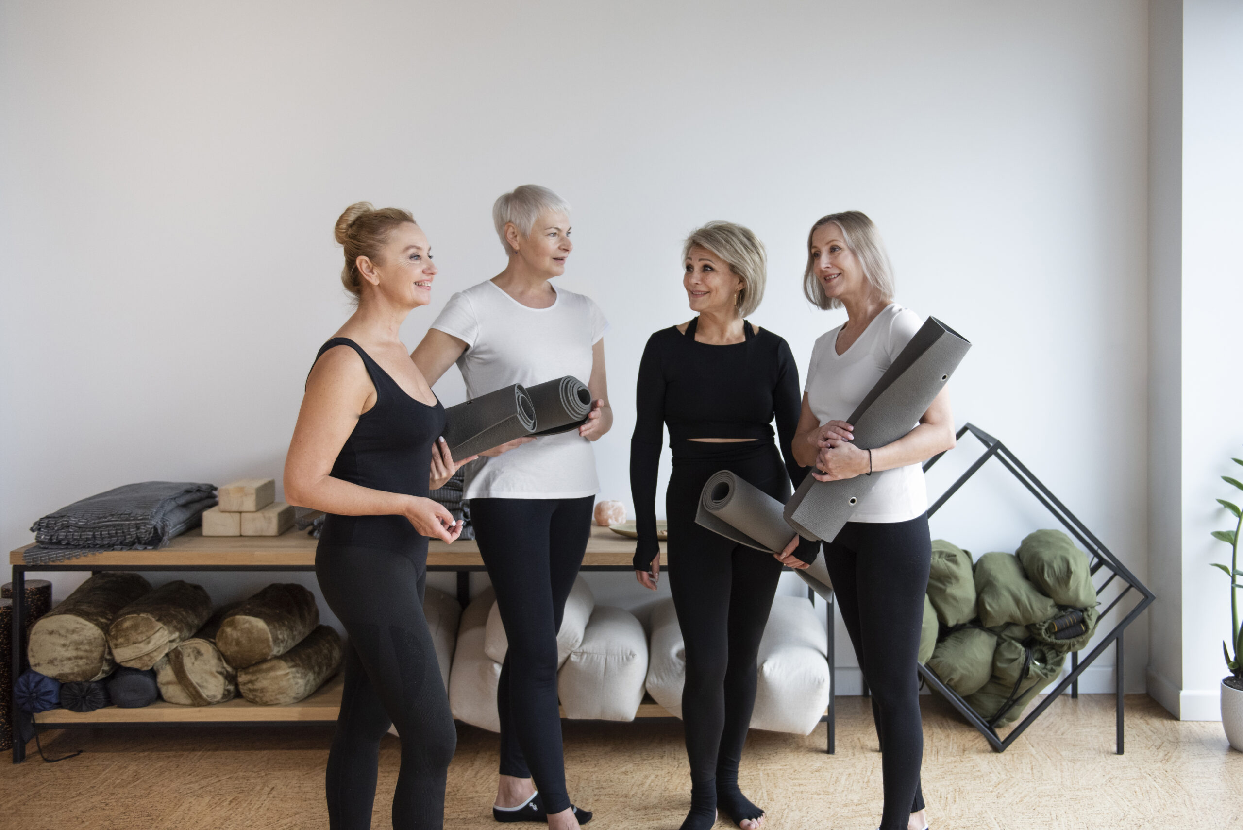 Four women with yoga mats - Pathfinder Fitness