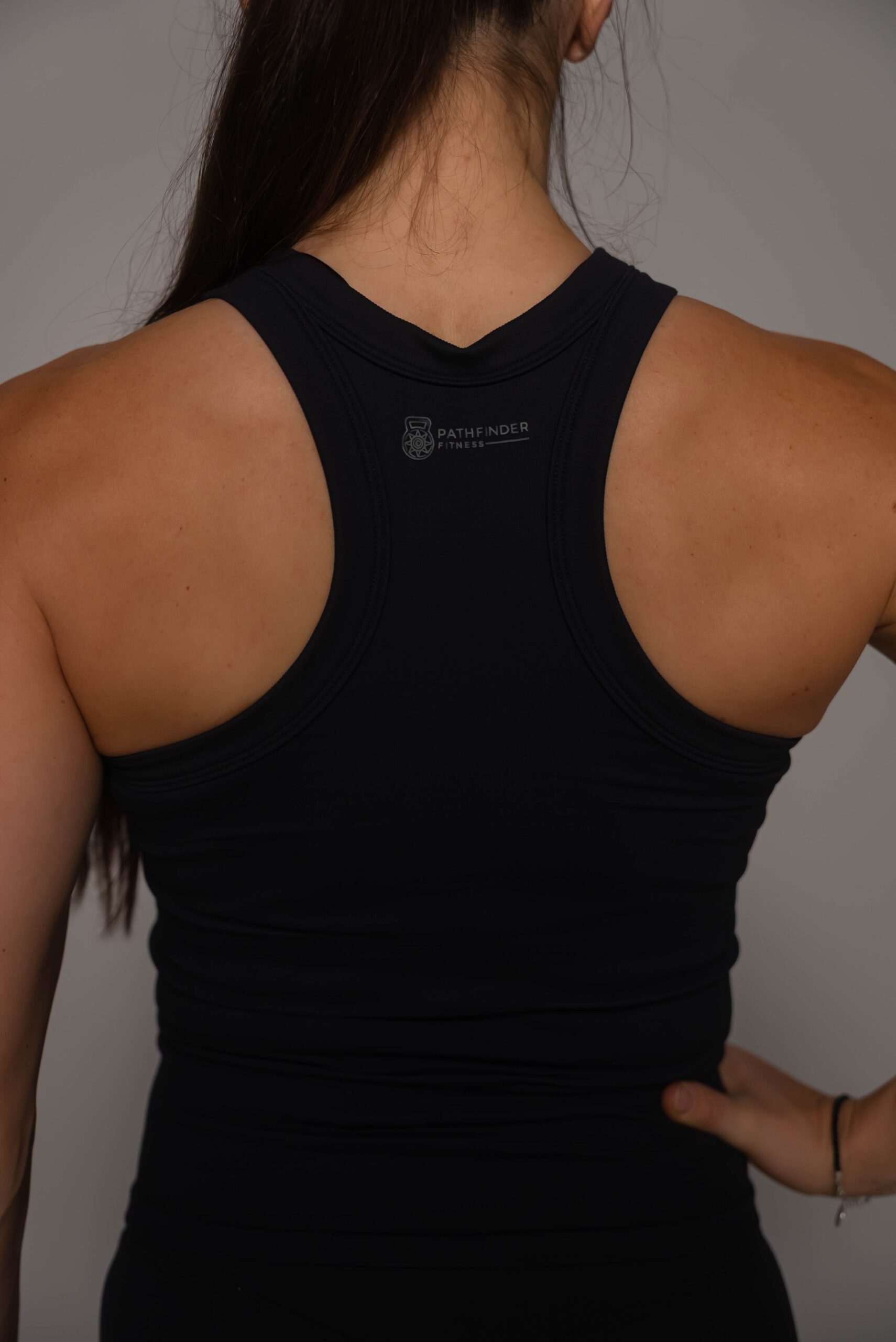 Women's wearing White Tank Top - Pathfinder Fitness