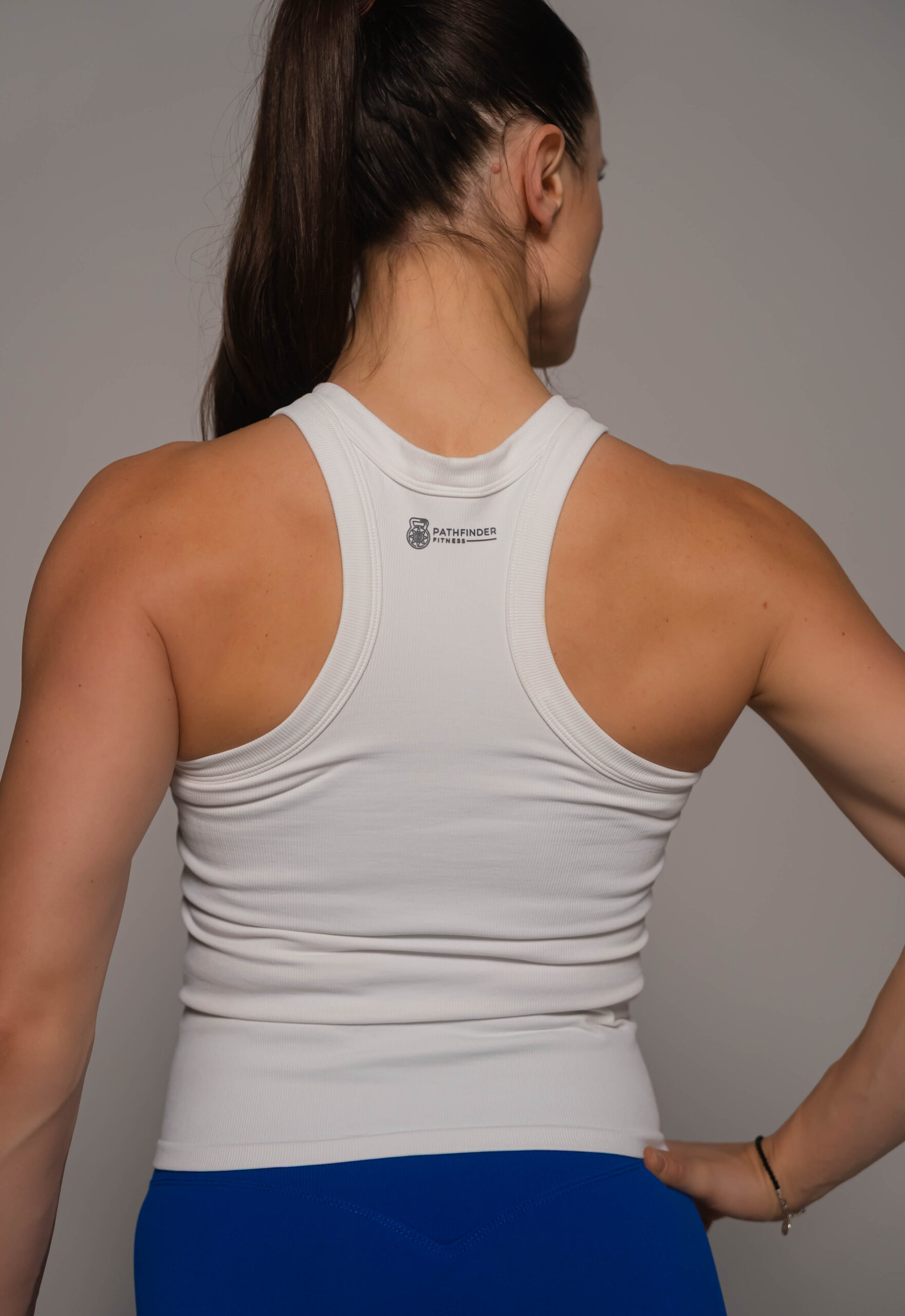 Women's wearing White Tank Top - Pathfinder Fitness